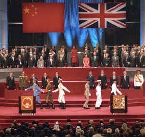 The extravagant ceremony ended 156 years of British colonial rule over the territory. This file photo dated 01 July, 1997 shows a Chinese soldier (2nd L) holding the national flag prior to its raising as the British military march at right during the official handover ceremony at the Hong Kong Convention and Exhibition Centre.