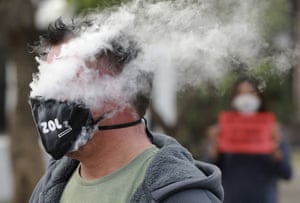 Cape Town, South Africa A demonstrator exhales smoke while wearing a face mask during a protest against the ban on cigarette sales during the country’s coronavirus lockdown