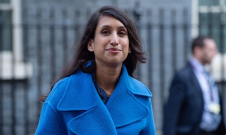 Claire Coutinho in a blue coat walking along Downing Street