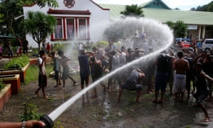 Drug users are hosed with water as part of their weekend drug rehabilitation programme..