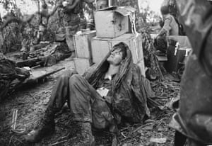 A US paratrooper wounded in the battle for Hamburger Hill grimaces in pain as he awaits medical evacuation at base camp near the Laotian border, May 19, 1969
