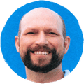 man smiling against blue background
