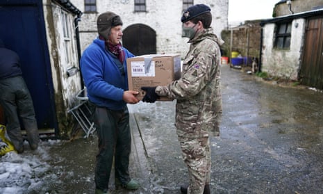 Soldier hands box to civilian
