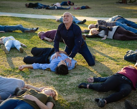 Man surrounded by dead people.