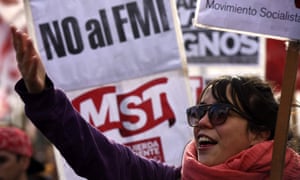 Demonstrators hold signs that read â€˜No to the IMFâ€™ in Buenos Aires