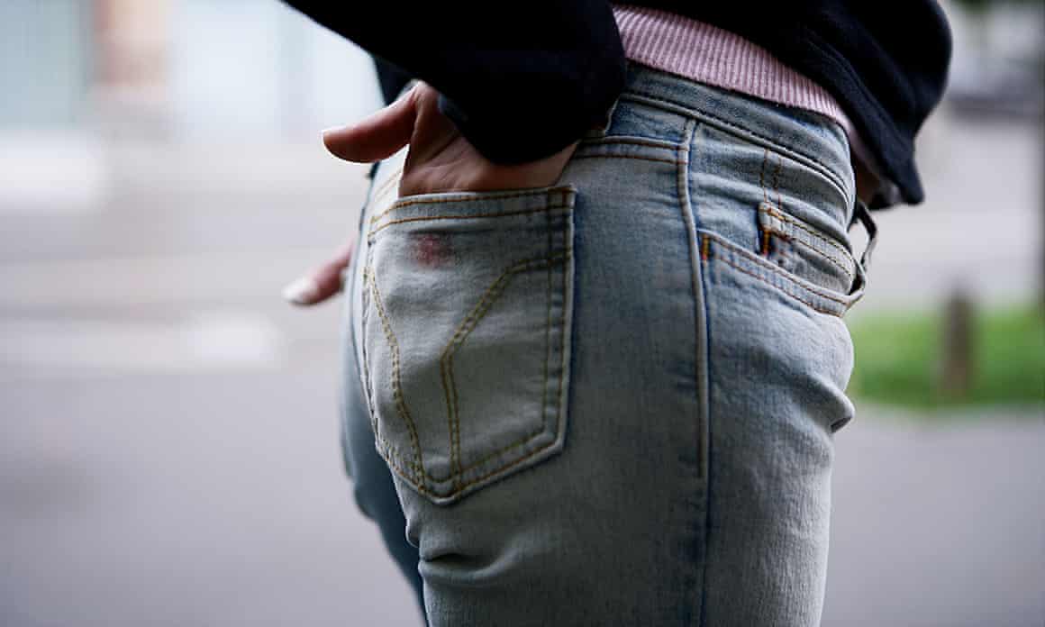 Side view of bottom of someone wearing jeans