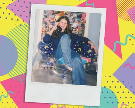 An old photo of a teenage girl sitting in an inflatable blue chair with stars and moons on it, using a brick phone