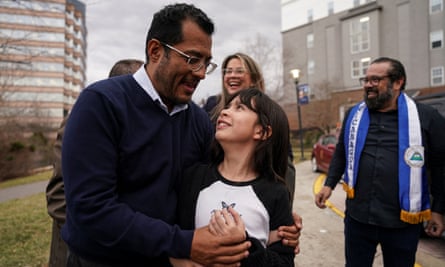 Former Nicaraguan presidential hopeful Félix Maradiaga embraces his daughter, Alejandra, as he celebrates with supporters and his wife, Berta Valle, outside a hotel after arriving in the US.
