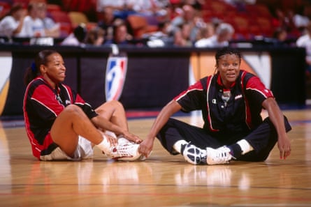 Cynthia Cooper, left, and Sheryl Swoopes stretch before a Houston Comets game.