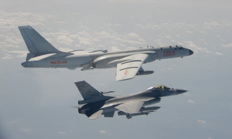 A Taiwanese F-16 fighter jet flies next to a Chinese H-6 bomber (top) in Taiwan airspace. China has sanctioned major US defence companies for selling weapons to Taipei.
