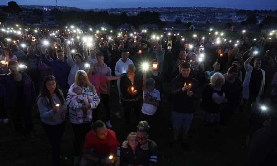 Flags at half mast in Plymouth with city still in shock from shooting | Plymouth shooting 1 People hold up candles and mobile phone torches during a vigil in Keyham