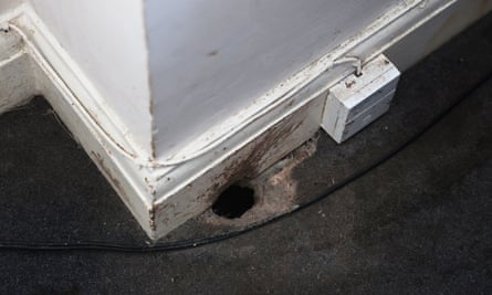 A rat hole in the corridor of temporary housing supplied to a mother and children.
