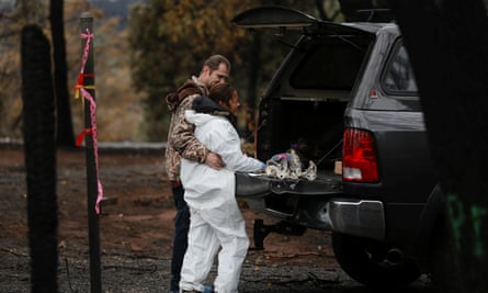 Brett Bizzle comforts his wife, Vanthy, who became emotional after returning to the remains of their home for the first time since the Camp fire forced them to evacuate Paradise.
