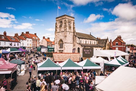 busy market town square with old church