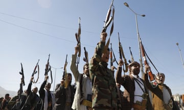 Houthi fighters hold up weapons in Sana’a, Yemen, earlier this year