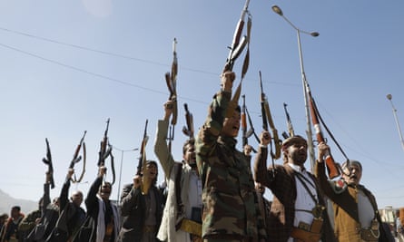 Houthi fighters chant slogans in a ceremony at the end of their training.