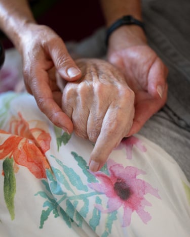Corinna and Rainer, Berlin-Prenzlauer Berg, two hands hold another over bedclothes