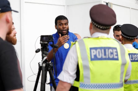 Officers support a Chelsea content creator as he tries to record a piece after Arsenal’s 2-1 victory.