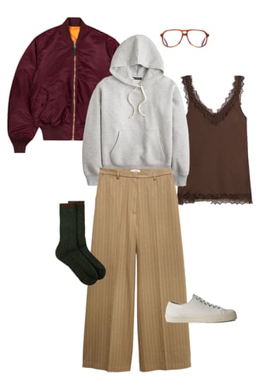 A composite image of a cherry red bomber jacket, grey hoodie, aviator-style glasses, brown lace cami top, beige pinstripe trousers, dark green socks and white plimsolls on a white background.