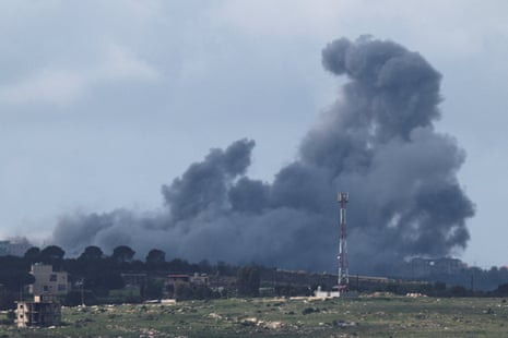 A distant view of Lebanon with a huge cloud of smoke rising in the sky.