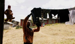 Josephine Wanjiru, 19, collects laundry outside a dormitory at the school