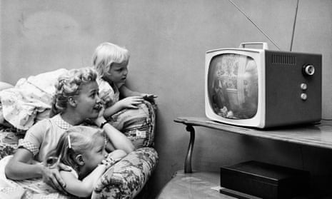 A family watching television in their home, circa 1955. 