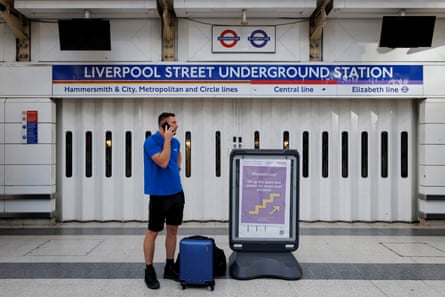 A commuter outside the closed Liverpool Street tube station due to a tube strike that has shut down nearly all London Underground services in London, Britain