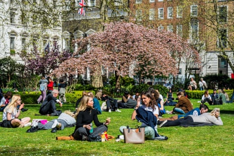 People taking their lunch break in the sun in St James’s Square, London