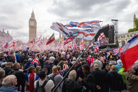 People gathered in front of parliament waving flags