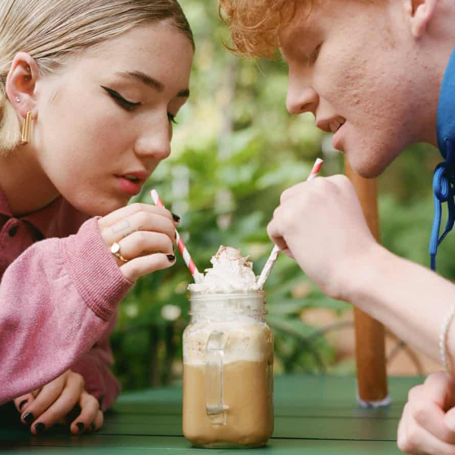 Teens sharing a frothy coffee