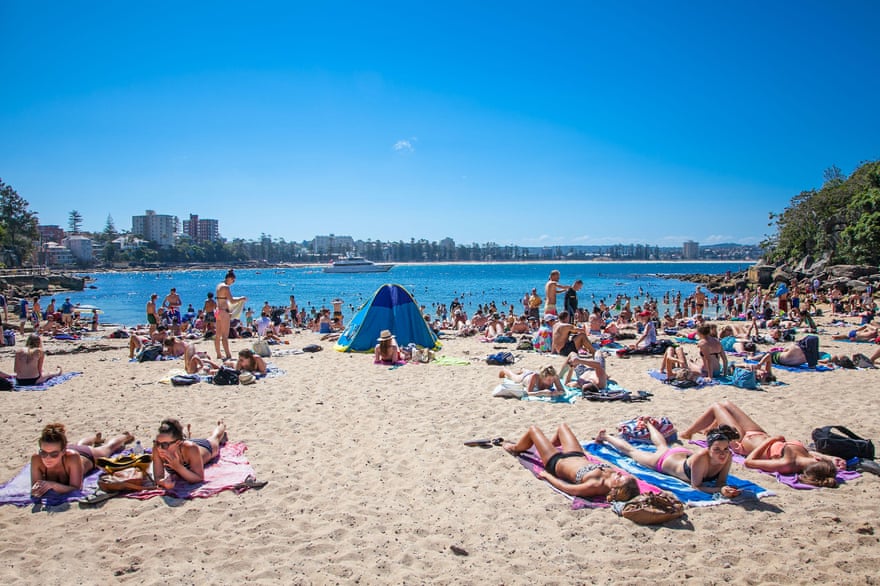 People relaxing on sandy Shelly beach at Manly in Sydney, Australia