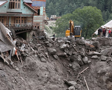 Rescue workers use earthmovers in the search for missing people after deadly flash floods in in Kishtwar district of Indian-administered Kashmir
