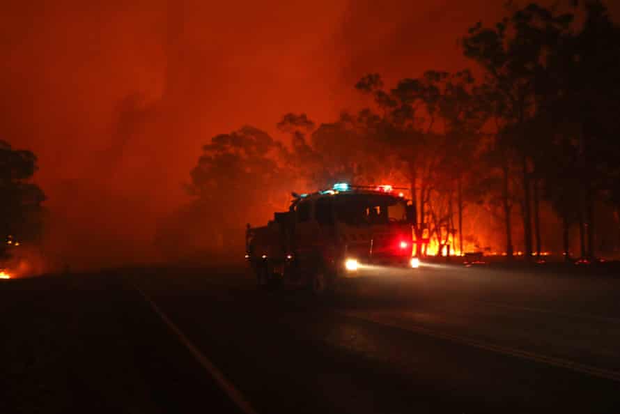 Flames rage near properties on the Sussex inlet road, south of Nowra.