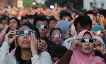 Always use eclipse glasses when looking at the sun, as these people did for the Indonesia eclipse of 2016.