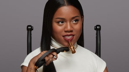Woman holding an accessible makeup applicator with a lipstick attached to it.