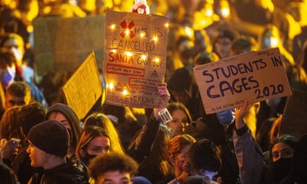 Students protest and march through the campus after tearing down fences at Manchester University.