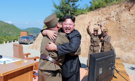 This picture taken on July 4, 2017 and released by North Korea’s official Korean Central News Agency (KCNA) on July 5 shows North Korean leader Kim Jong-Un (C) celebrating the successful test-fire of the intercontinental ballistic missile Hwasong-14 at an undisclosed location