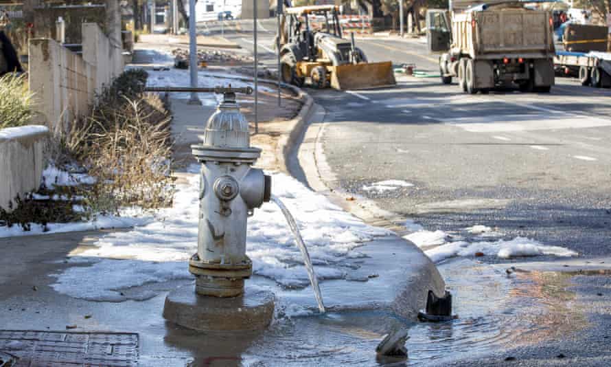 Water trickles from a fire hydrant while workers repair a broken water main in Austin, Texas, on 21 February. The majority of water and wastewater systems nationwide are also unprepared to cope with the climate crisis.