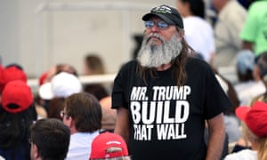 A Trump supporter in a T-shirt reading 'Mr Trump, Build That Wall'