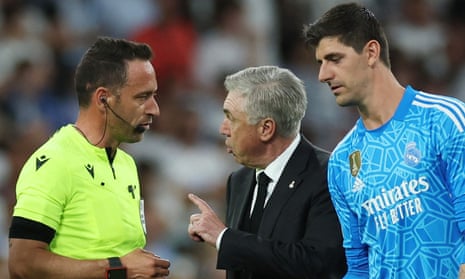 Real Madrid coach Carlo Ancelotti speaks to referee Artur Soares Dias after the match.