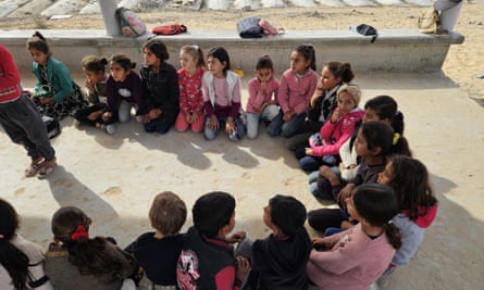 Small children sitting on ground in circle