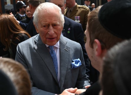 King Charles shaking hands with someone.