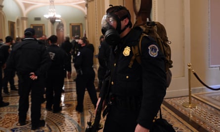 A US Capitol police officer wears a gas mask.