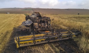 A burnt-out combine harvester in Wiltshire. Their blades can strike a stone and create a spark, which could be enough to start a fire in dry conditions.