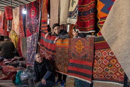 Rug vendors tend a stall at a weekly Friday market in Tehran on Friday.