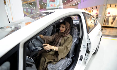 A Saudi woman tries out a car at a showroom in Jeddah