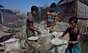 Mohammad Alamgir, 24, Mohammad Hasan, 16, and Biplop Mohammad, 13, bag animal fat that will be turned into soap.