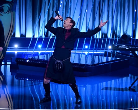 David Tennant wearing a kilt and singing on stage at the Baftas