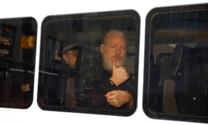 Julian Assange is seen in a police van after was arrested by British police.