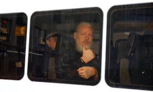 Assange in a police van after he was arrested by British police.
